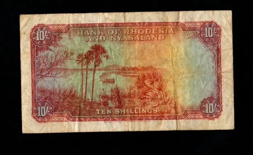 Back of 1956 Bank of Rhodesia and Nyasaland 10 Shillings note showing a river landscape with palm trees.
