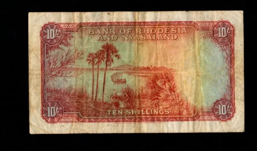 Back of 1956 Bank of Rhodesia and Nyasaland 10 Shillings note with river landscape and palm trees.