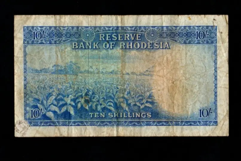 Back of 1964 Rhodesia 10 Shillings banknote showing a tobacco field and agricultural landscape.