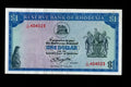 Front of a circulated 1978 Rhodesia 1 Dollar banknote featuring the Balancing Rocks and serial number L/100 404023.