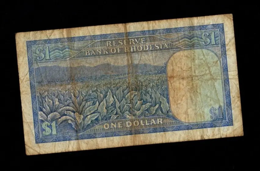 Reverse of a 1978 Rhodesia 1 Dollar note showing a tobacco field and mountain landscape.