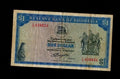 Front of a circulated 1978 Rhodesia 1 Dollar banknote with Balancing Rocks and red serial numbers