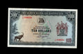 Front of 1978 Rhodesia 10 Dollar banknote featuring a Sable Antelope and red serial numbers.
