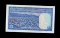 Reverse of 1979 Rhodesia 1 Dollar note showing a tobacco plantation field and mountain background.