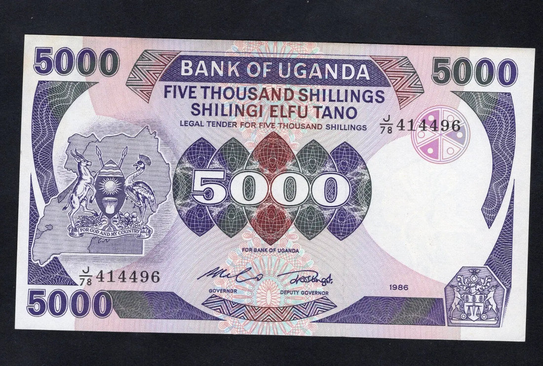 Front and back of an uncirculated 1986 Uganda 5000 Shillings banknote featuring the coat of arms and Makerere University.