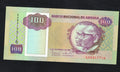 Front and back of an uncirculated 1991 Angola 100 Kwanzas banknote featuring Dos Santos, Neto, and the Pedras de Pungo Andongo