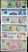 Stack of vintage Vietnamese banknotes in various denominations featuring Ho Chi Minh portrait