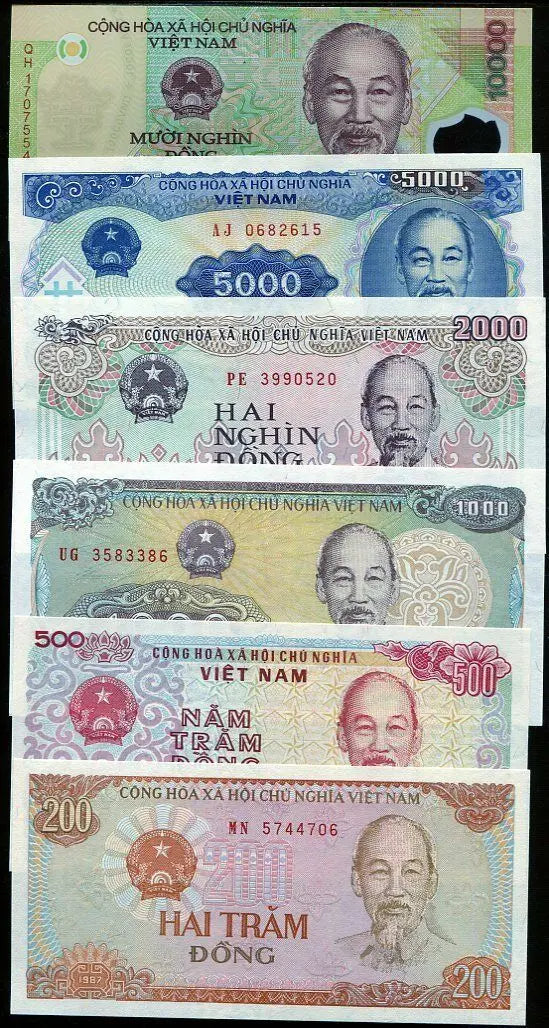 Stack of vintage Vietnamese banknotes in various denominations featuring Ho Chi Minh portrait