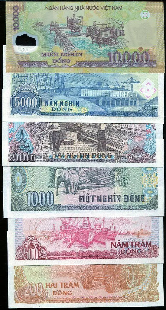 Vietnamese dong banknotes collection featuring various denominations and industrial scenes.