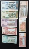 Collection of Mongolian banknotes with traditional designs, livestock, and mountains.