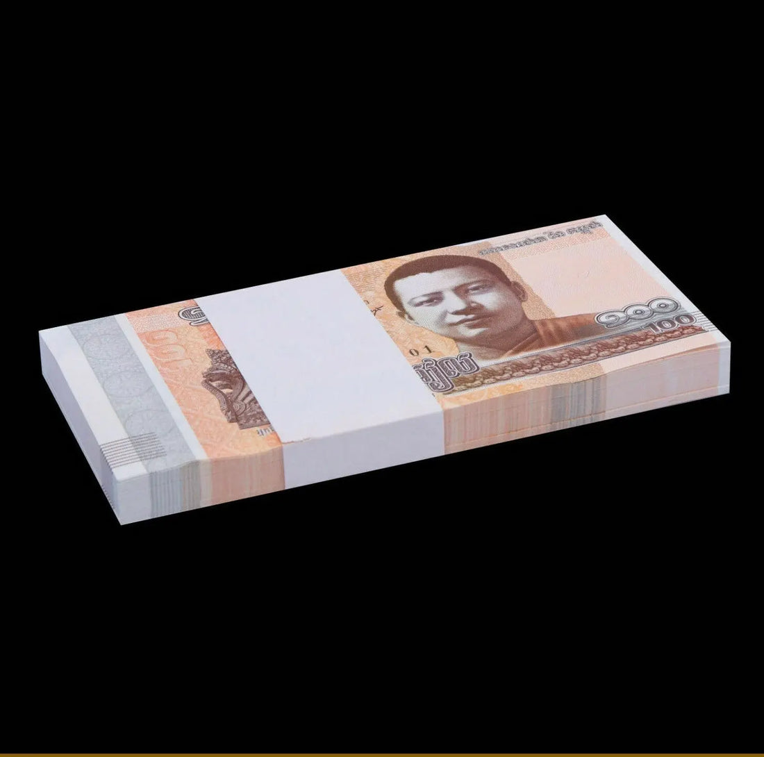 Stack of 100 Cambodian riel banknotes with portrait, currency collection on black background