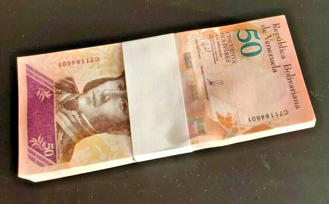 Bundle of Venezuela 50 Bolivares banknotes on dark surface, collectible world currency