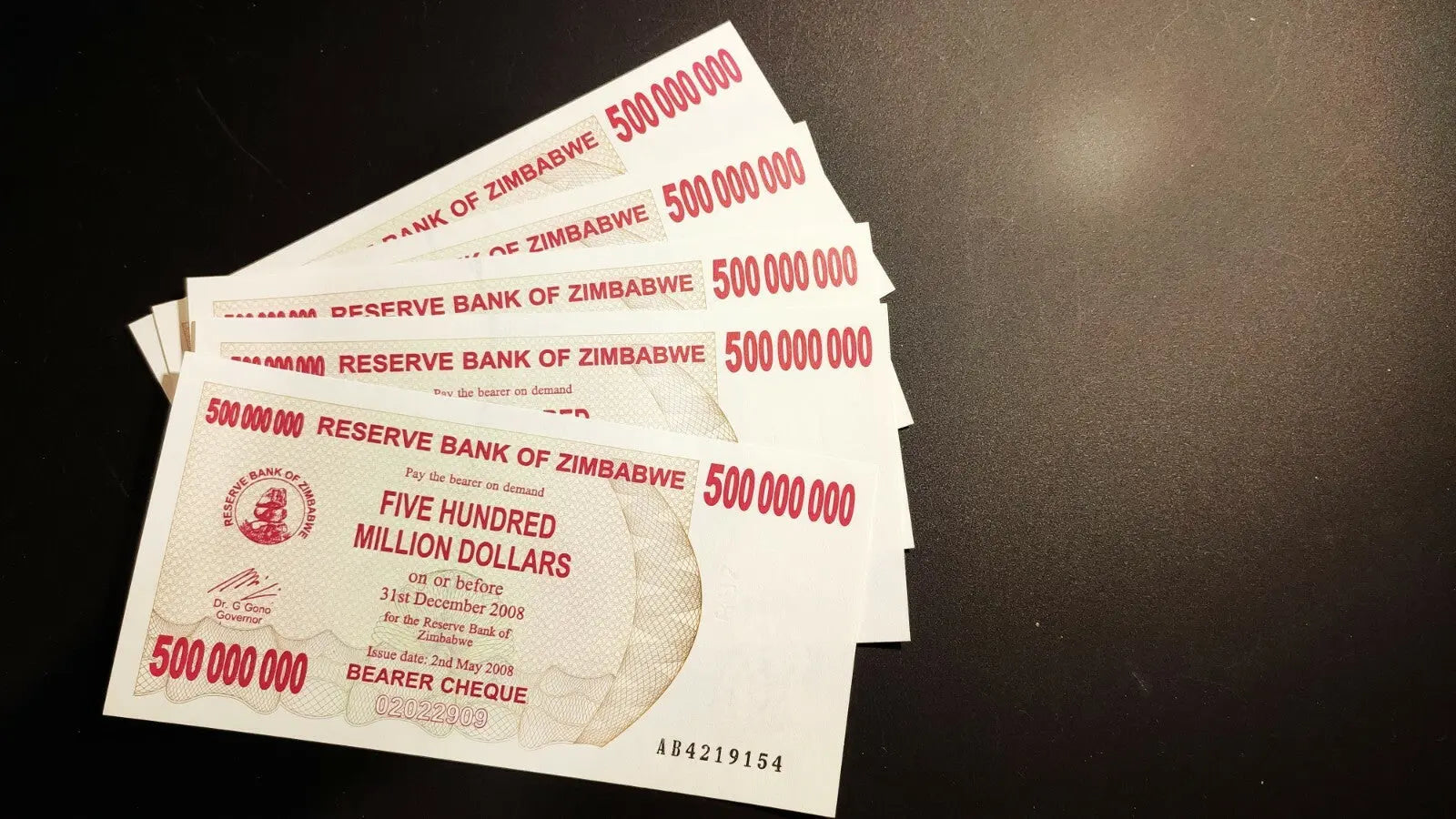 Stack of Zimbabwe 500 million dollar banknotes on black background, collectible currency