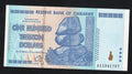 front of Zimbabwe 100 Trillion Dollar banknote. Genuine, AUNC AA Serial Number UV checked