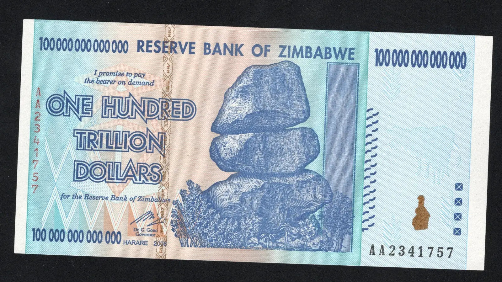 front of Zimbabwe 100 Trillion Dollar banknote. Genuine, AUNC AA Serial Number UV checked