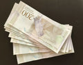 Stack of 200 bolívares Venezuelan banknotes featuring bird design on dark surface