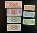 Assorted Chinese banknotes from different denominations displayed on a black background.