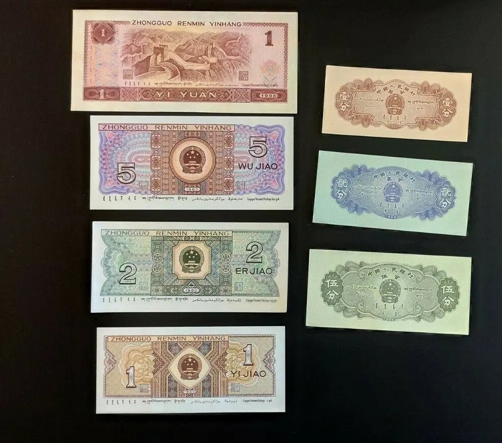 Assorted Chinese banknotes from different denominations displayed on a black background.