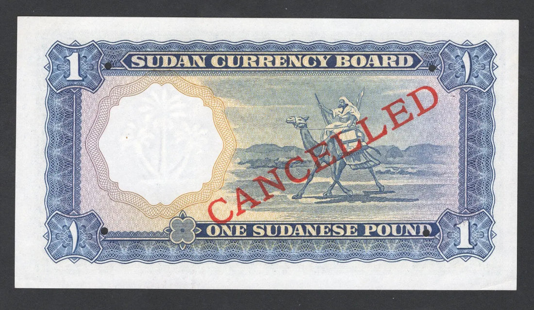 Actual photo of a rare 1956 Sudan 1 Pound specimen banknote, Pick 3s, serial C/13 000000, overprinted CANCELLED in red, UNC condition.