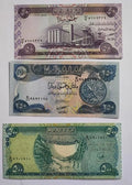 Three colorful world banknotes with detailed Arabic script, landmarks, and nature scenes