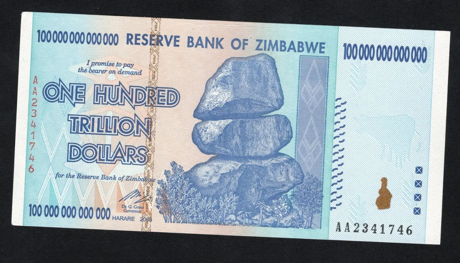 front of Zimbabwe 100 Trillion Dollar banknote. Genuine, AUNC AA Serial Number UV checked