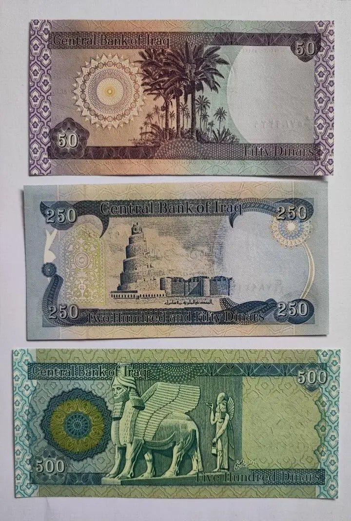 Assorted Iraqi dinar banknotes featuring landmarks and historic designs