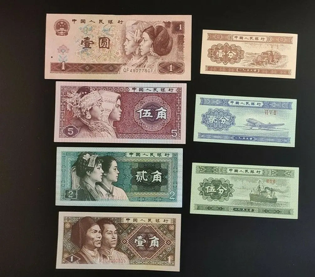 Assorted Chinese banknotes featuring portraits and transport illustrations on black background