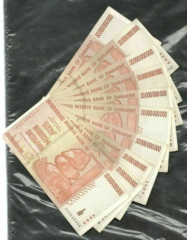 Stack of Zimbabwe 50 billion dollar banknotes fanned out on a dark background