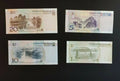 Chinese yuan banknotes featuring landscapes, 20, 10, 5, and 1 yuan notes on black background