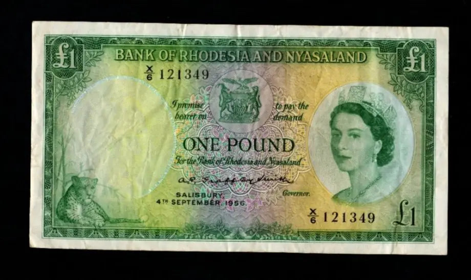 Front and back of a 1956 Bank of Rhodesia and Nyasaland 1 Pound banknote featuring Queen Elizabeth II, a leopard, and the Great Zimbabwe Ruins