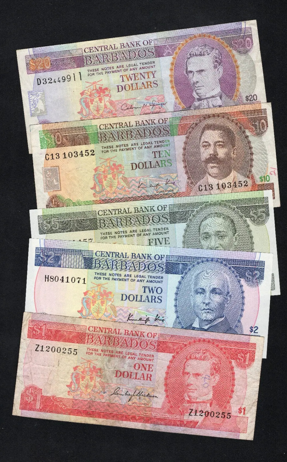 A set of five circulated Barbados banknotes in various colors ($1, $2, $5, $10, and $20) displayed together.