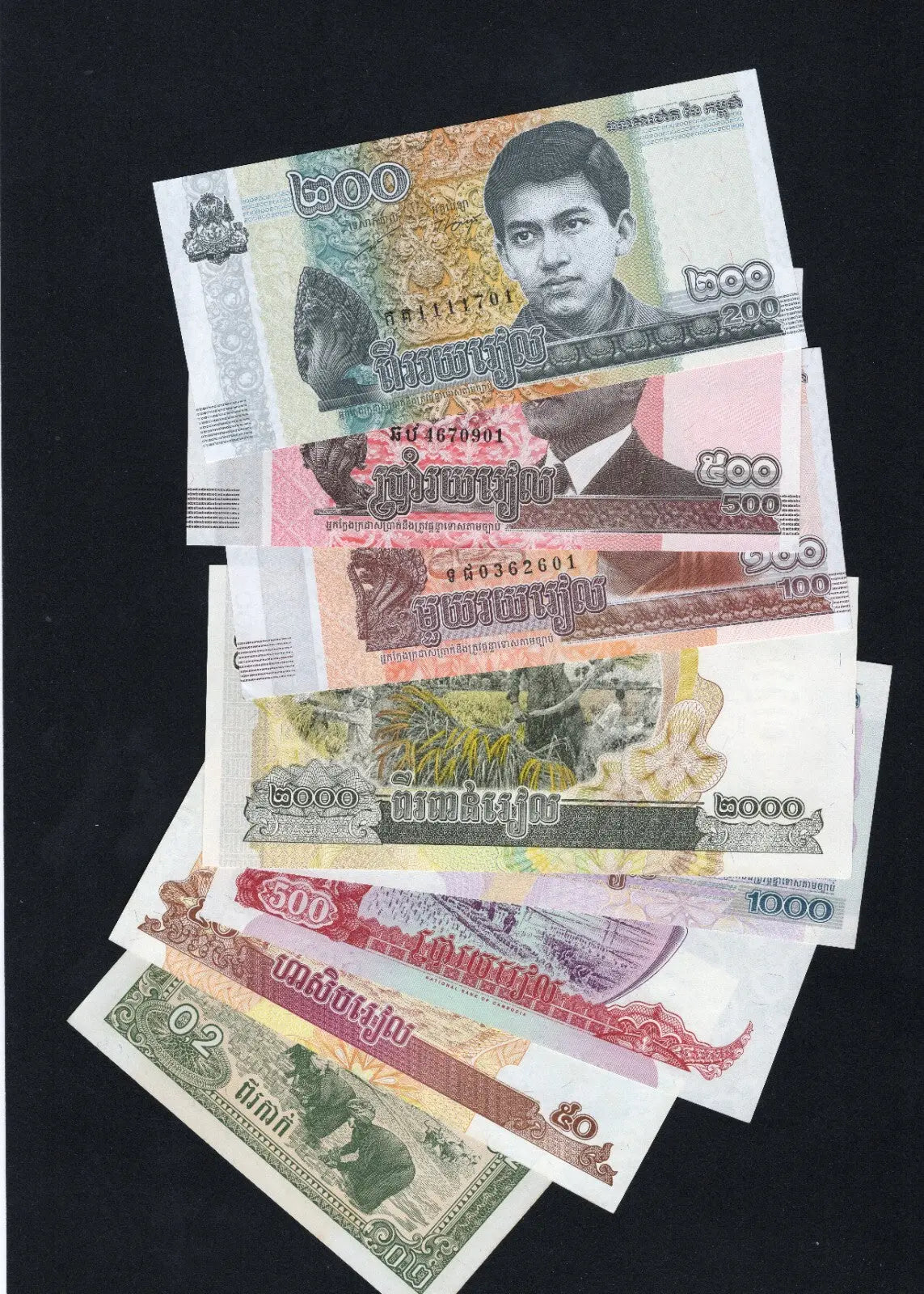 SA collection of 8 Cambodian Riel banknotes from 1979 to 2022, featuring King Sihamoni and Angkor Wat landmarks.