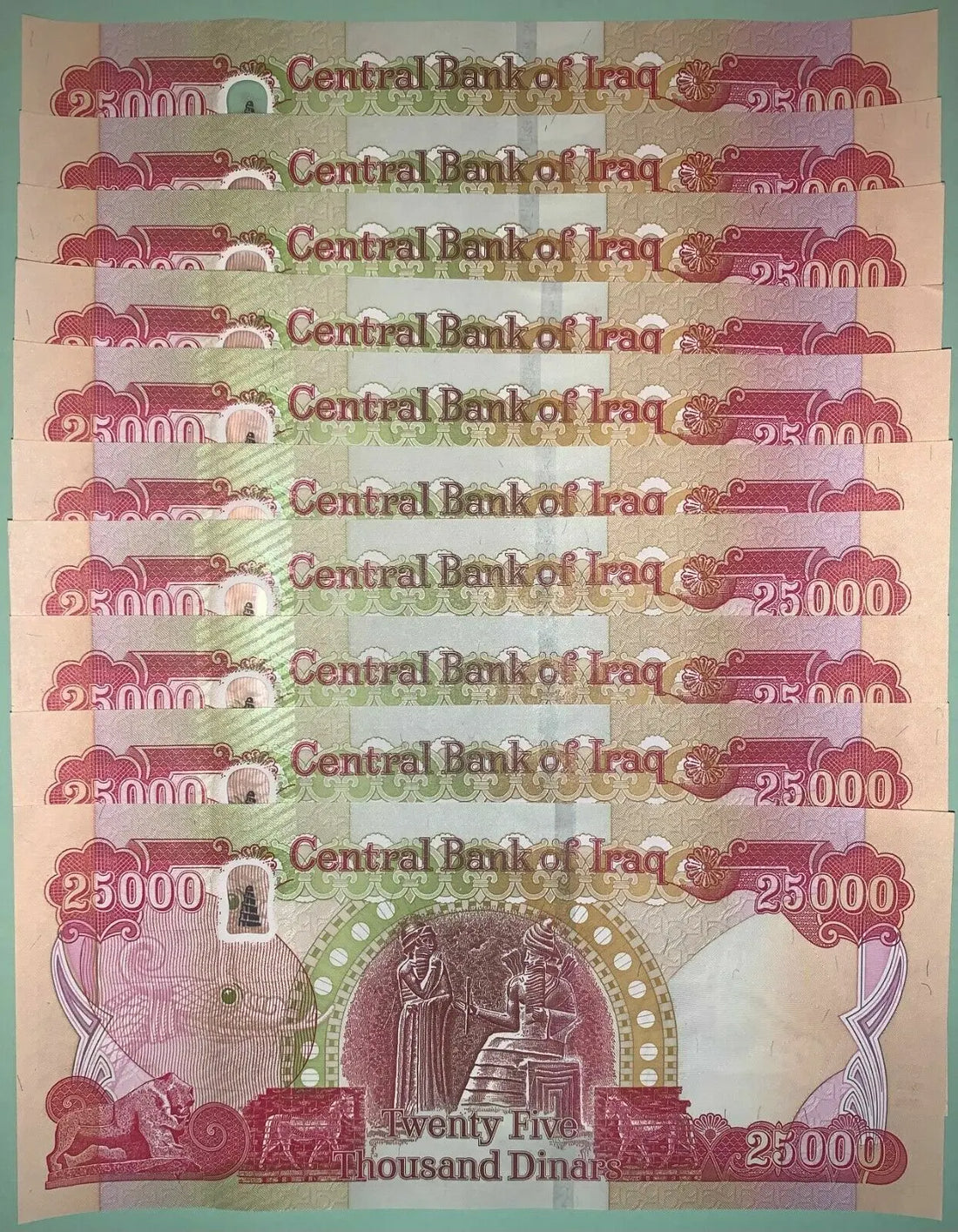 Wholesale stack of 82 uncirculated 2021 Iraq 25,000 Dinar banknotes featuring a Kurdish farmer and King Hammurabi.