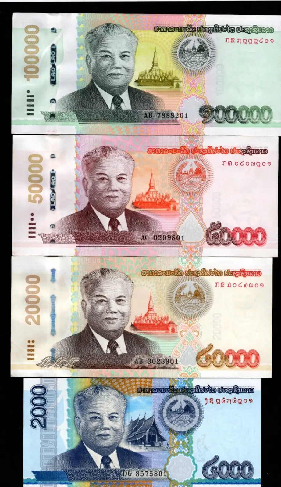 A set of 4 Laotian Kip banknotes featuring President Kaysone Phomvihane in various denominations and colors.