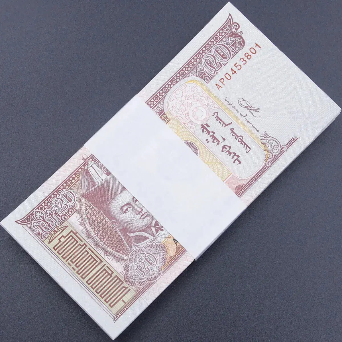 A complete bank bundle of 100 uncirculated 2018 Mongolia 20 Tögrög banknotes featuring Damdin Sükhbaatar and grazing horses.