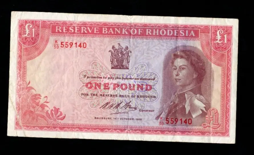 Authentic 1968 Rhodesian 1 Pound banknote, Pick 28b, featuring Queen Elizabeth II and Victoria Falls in circulated condition.