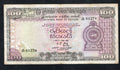 Actual photo of a circulated 1977 Sri Lanka 100 Rupees banknote, Pick 82a, featuring the Armorial Ensign and Polonnaruwa Vatadage ruins.